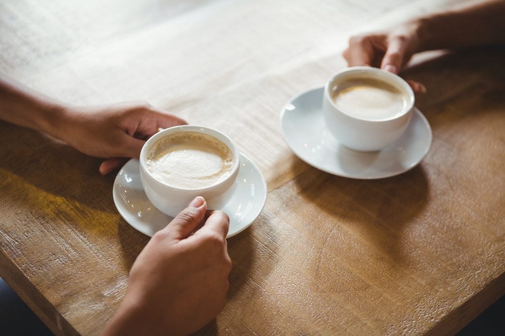 Close up of two cups of coffee on table